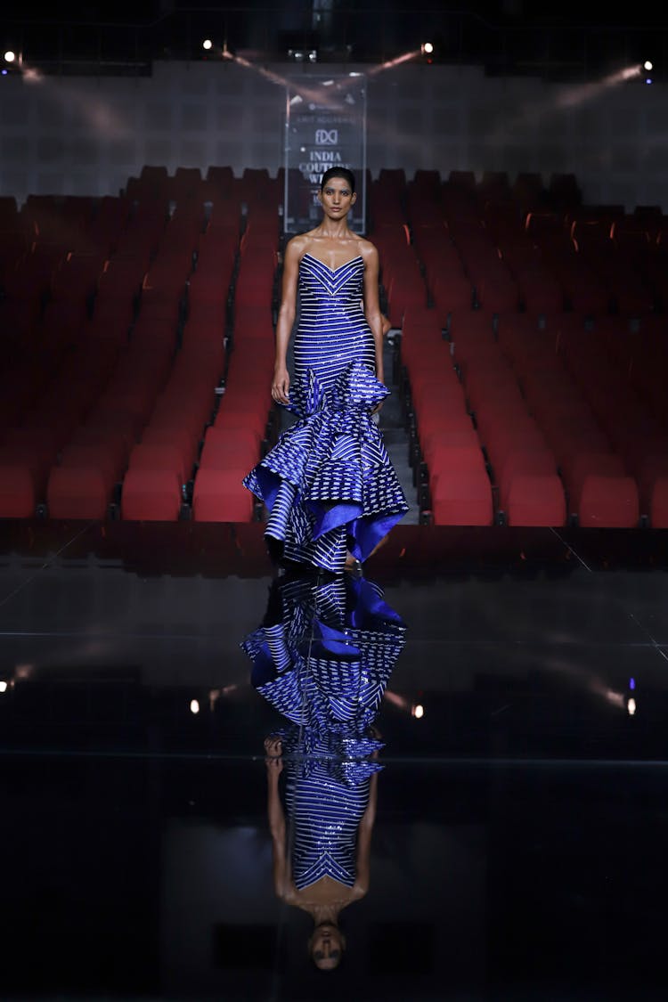 Fashion Model In Elegant Blue Stripes Long Dress Walking On Stage