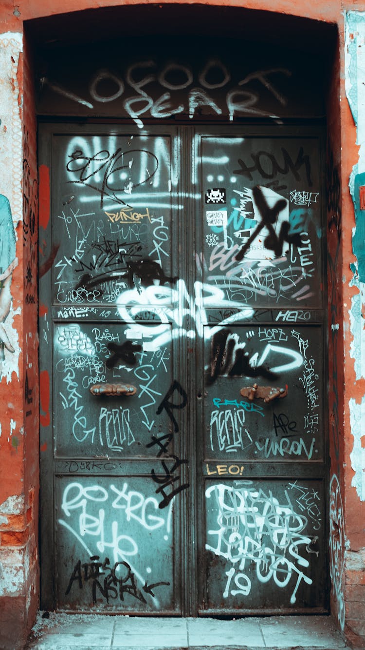 A Vandalized Door Of A Building