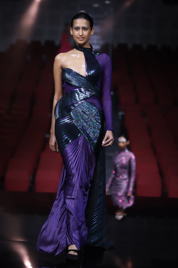 Fashion Model In Elegant Purple Gown Walking On Stage