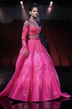 Fashion model wearing a striking gown on the runway, showcasing couture in New Delhi.