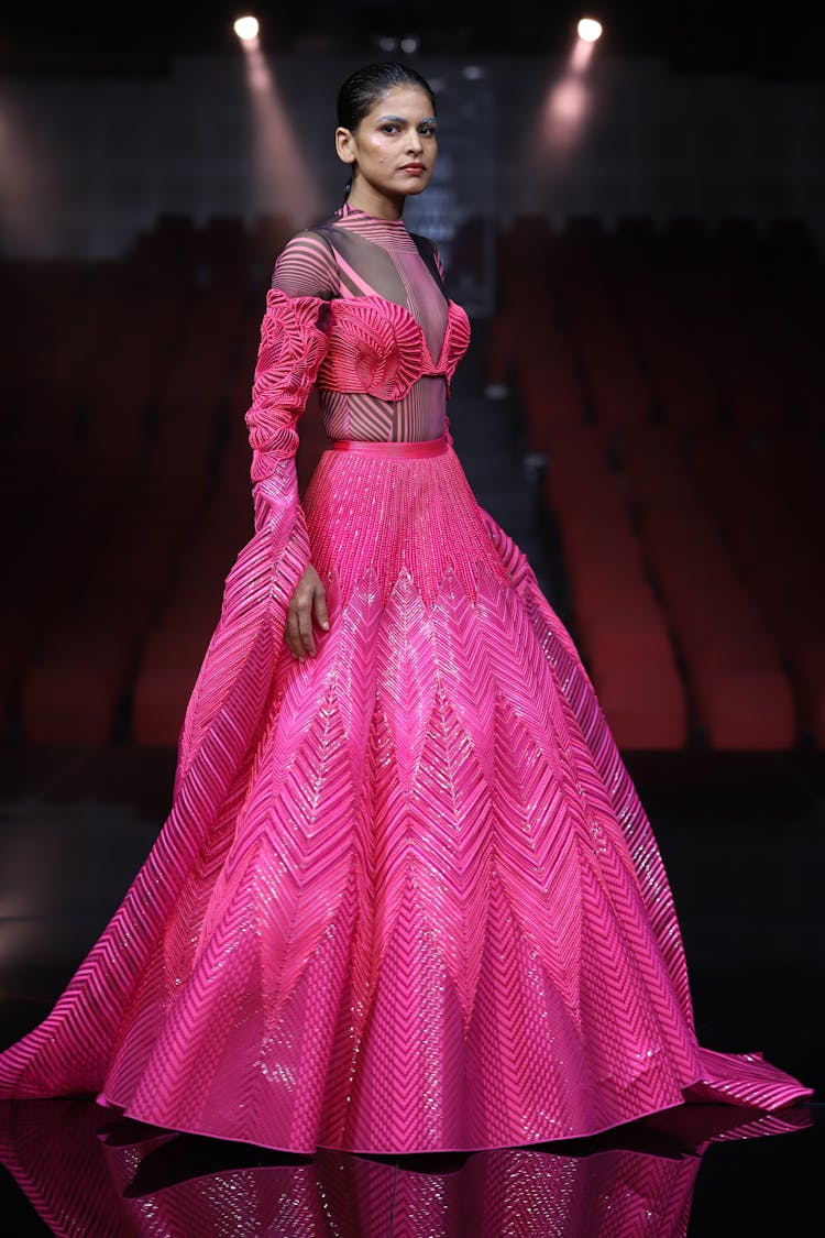 Fashion Model In Elegant Pink Gown Walking On Stage