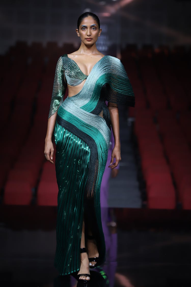 Fashion Model In Elegant Dark Green Gown Posing On Stage