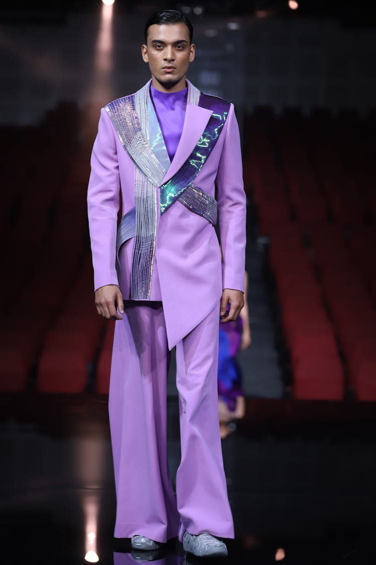 Fashion Model In Purple Formal Wear Posing On Stage