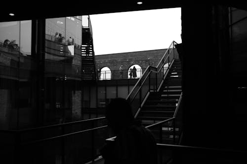 Grayscale Photo of a Staircase beside a Building