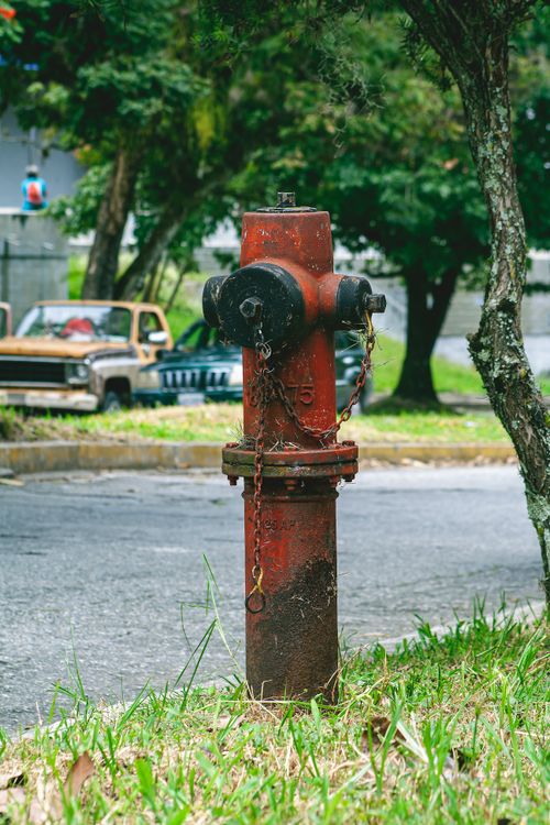 Free Weathered fire hydrant on a Venezuelan street depicting urban decay. Stock Photo