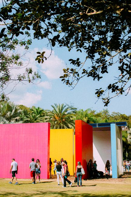Visitors explore vibrant outdoor art at a park in Brazil.