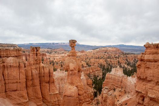 A captivating aerial view of iconic Bryce Canyon hoodoos during the day with a cloudy sky