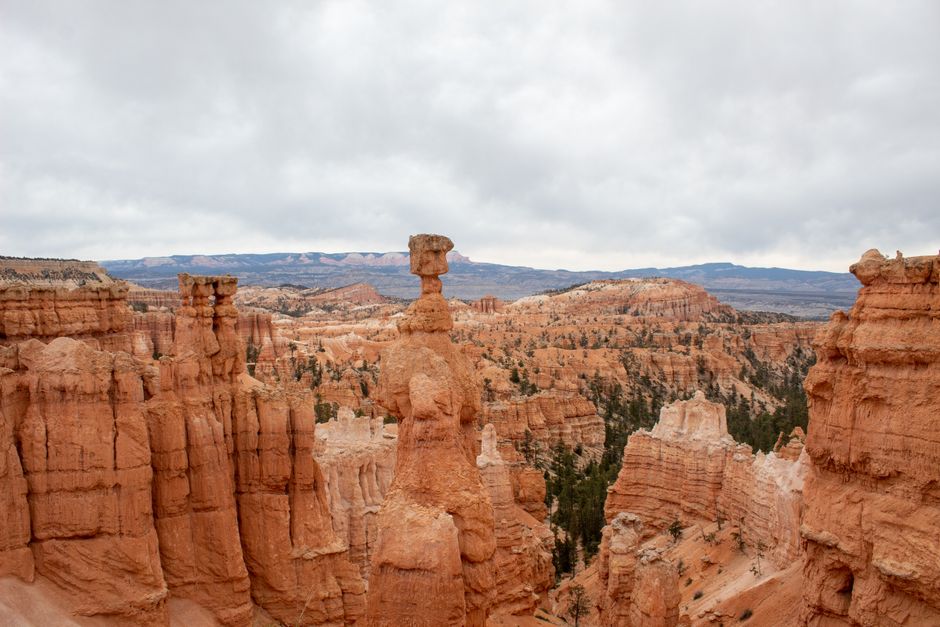 A captivating aerial view of iconic Bryce Canyon hoodoos during the day with a cloudy sky