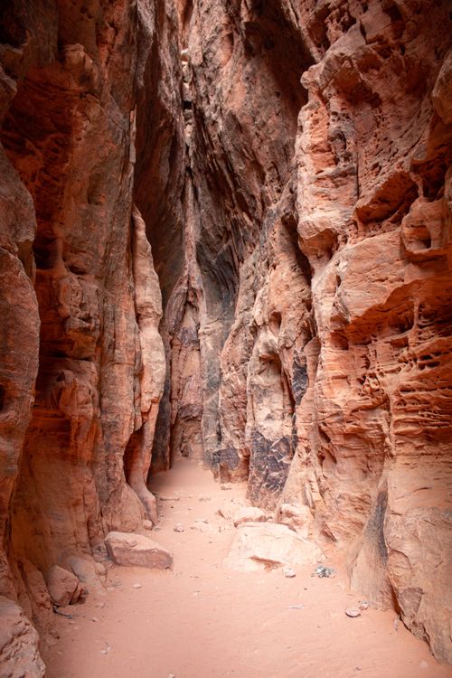 Free Explore the narrow, textured beauty of a sandstone slot canyon illuminated by warm, natural light. Stock Photo