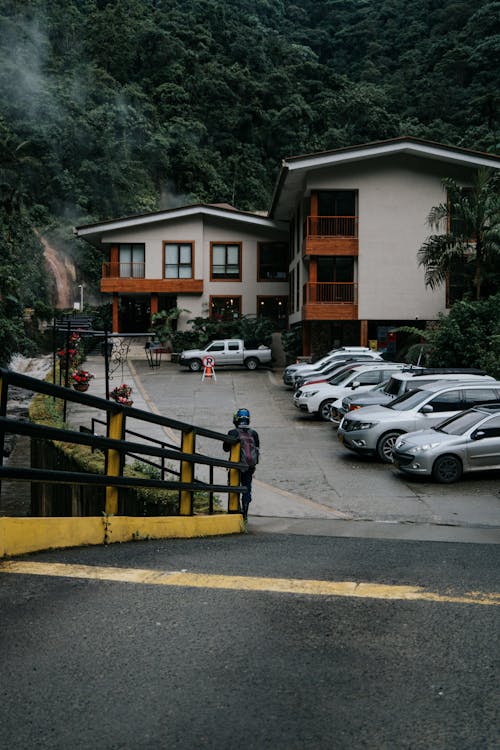 Asphalt Road Leading to a Resort Building in a Mountain Valley 