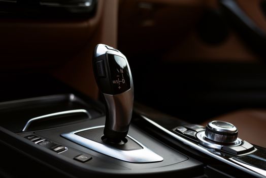 Close-up of a modern automotive gear shifter, highlighting contemporary design.