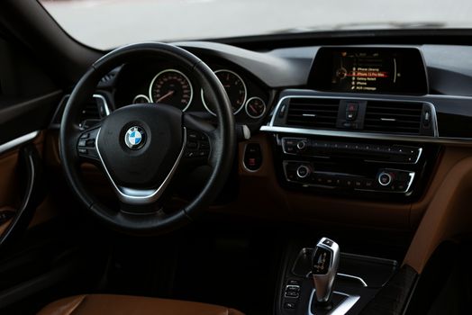 Elegant BMW interior featuring a sleek dashboard and steering wheel.