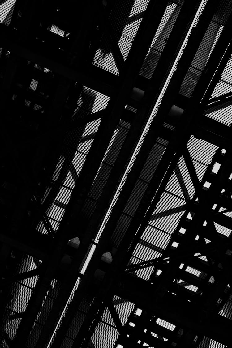 A Grayscale Of A Metal Structure From Below