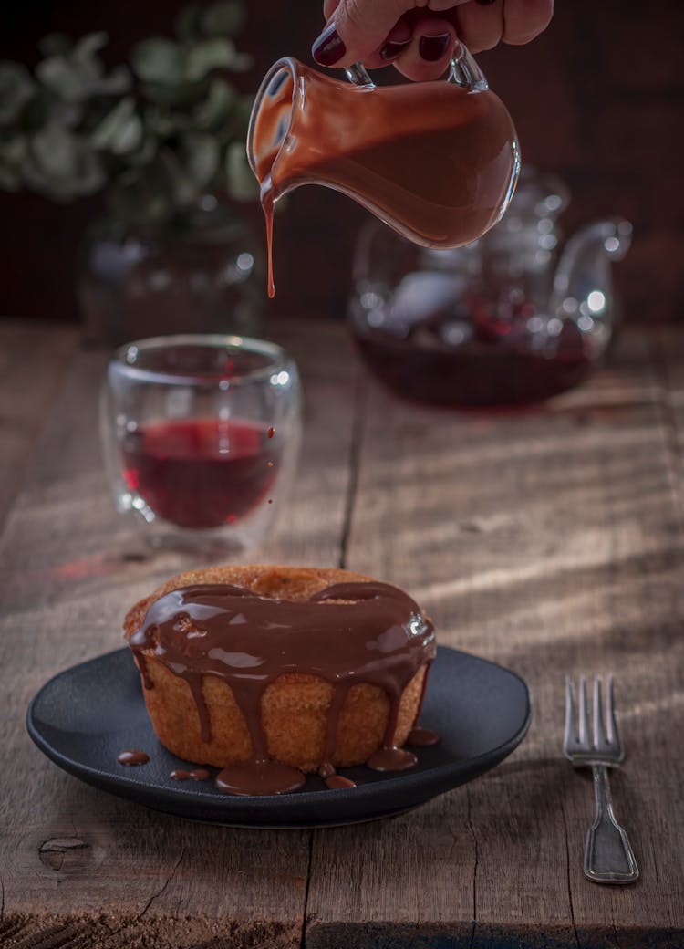 Pouring Chocolate Over A Cake