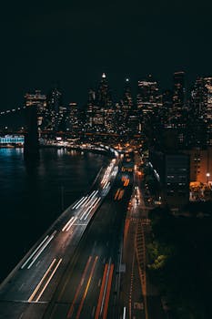 A breathtaking aerial view of a city skyline with vibrant light trails and dynamic urban landscape at night.