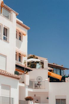 Stunning Mediterranean architecture with white facades and blue sky, emphasizing outdoor living.