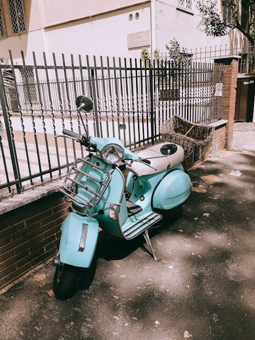 Blue Motor Scooter Parked on the Street