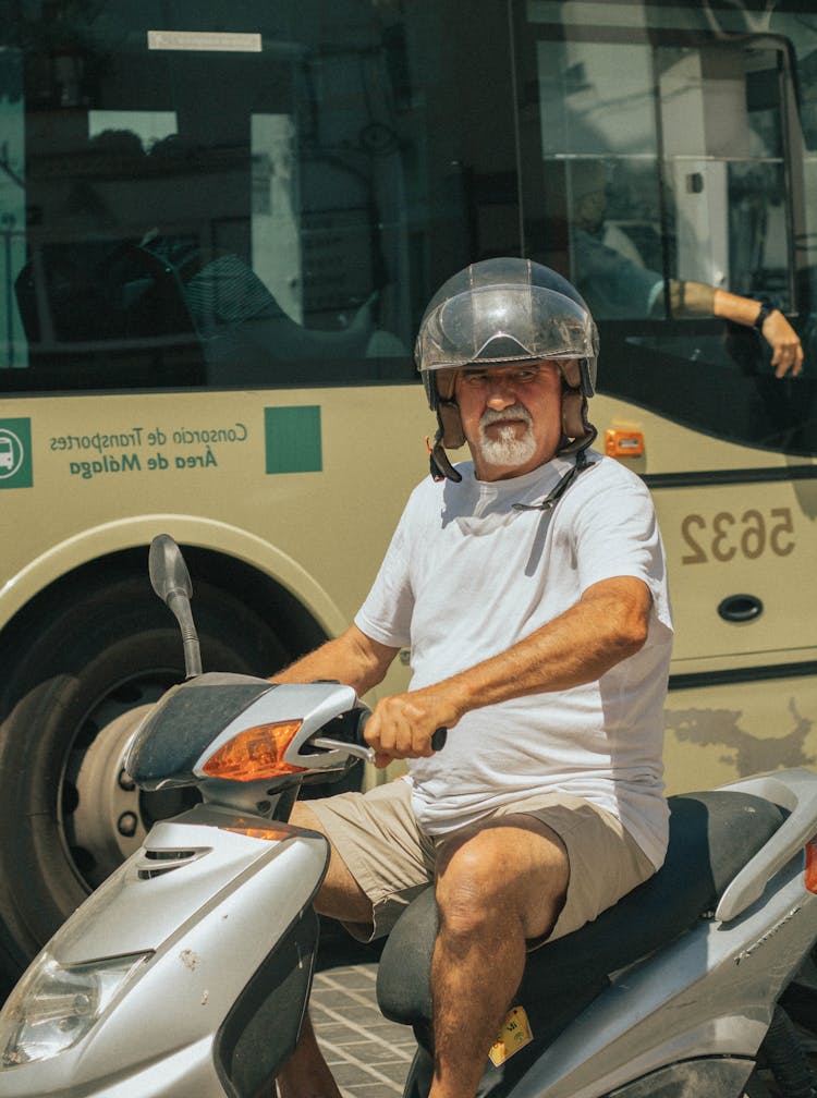 Elderly Man Riding A Scooter