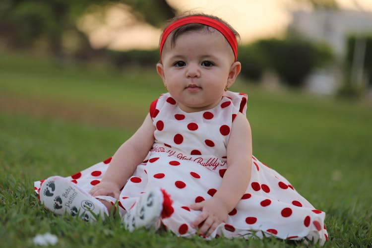 A Baby Girl In A Polka Dot Dress