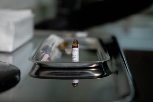 White Labeled Bottle on Stainless Steel Tray