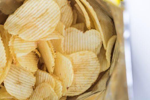Close-up of ridged potato chips inside an opened snack bag, ready to eat.