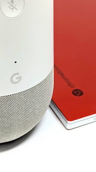A smart home speaker next to a red notebook, showcasing modern tech accessories.