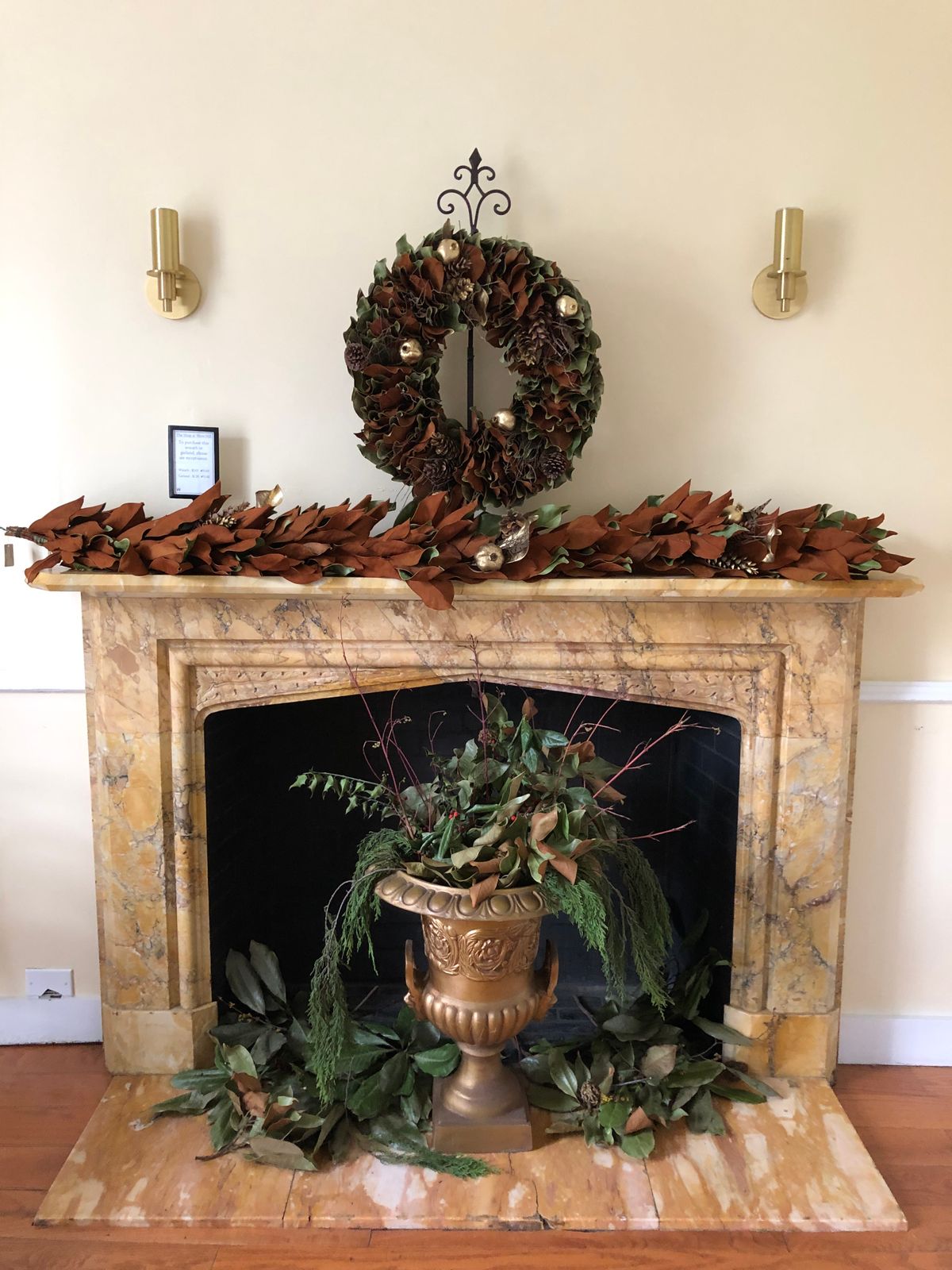 Cozy fireplace mantel with a seasonal wreath and candles for Halloween mantel decor ideas