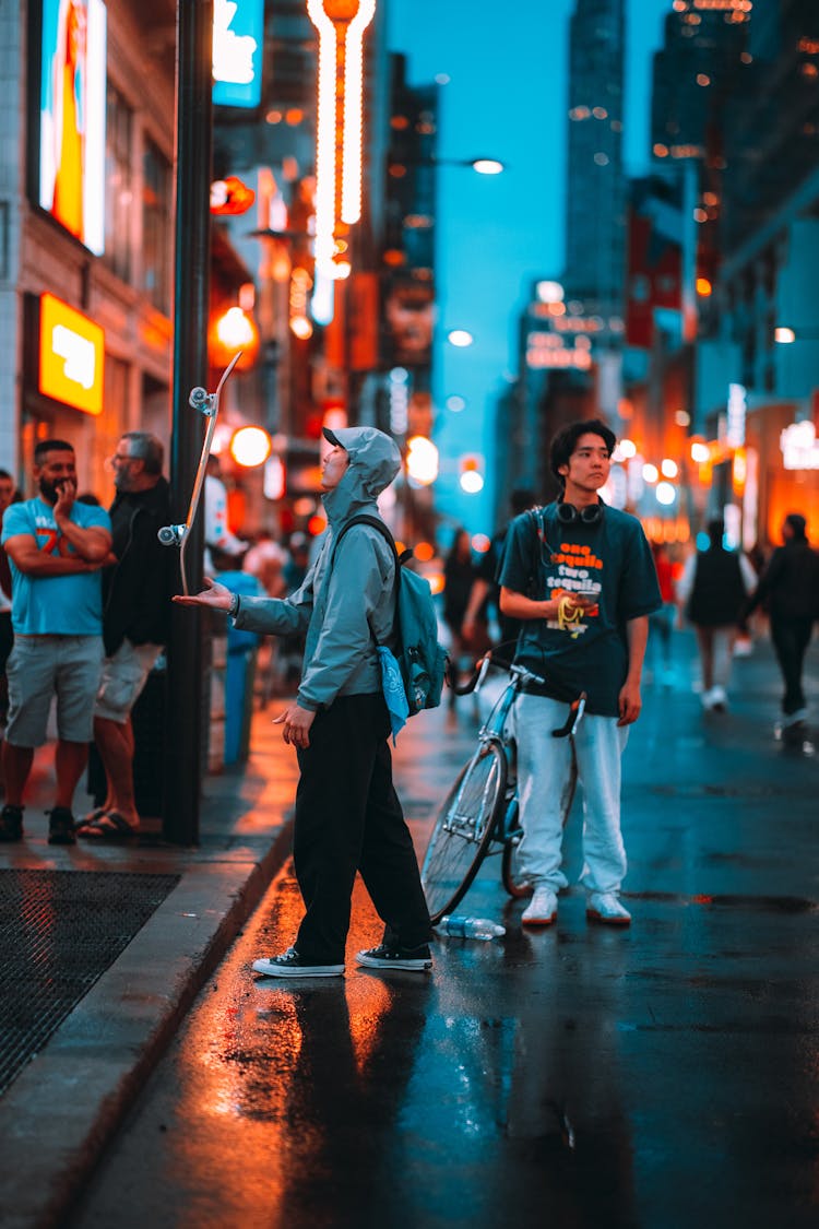 Kids Playing In Street Of Big City At Night