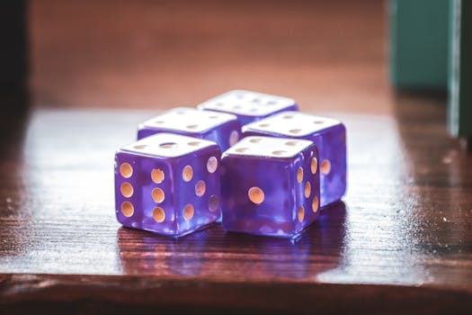 Vibrant blue dice on a wooden table, perfect for game night themes.