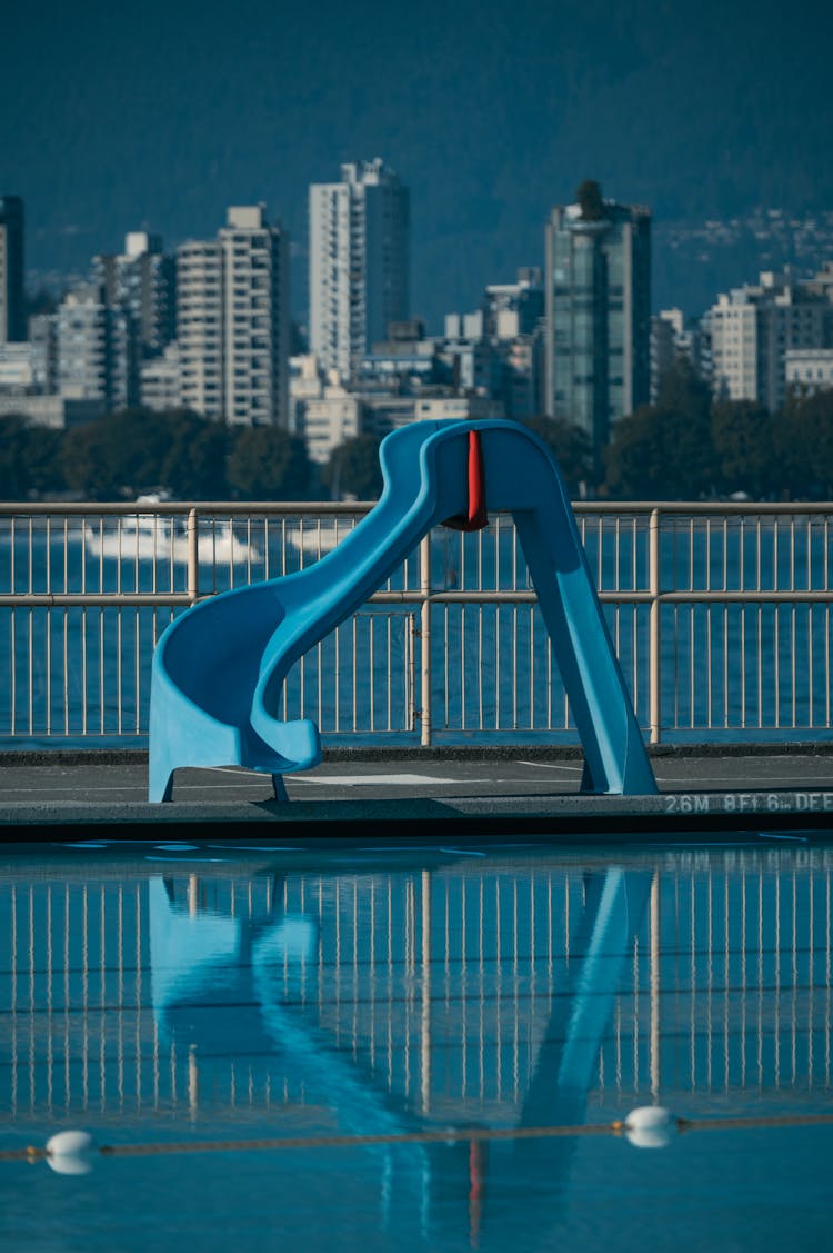 Empty Public Swimming Pool With Blue Slide