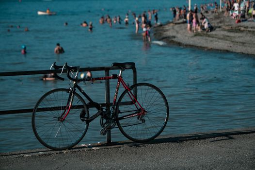 Bicycles and beachgoers enjoying a sunny day at Vancouver's famous beach.