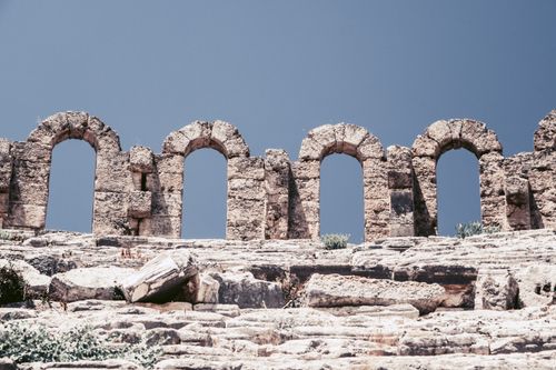 Free Explore the ancient stone arches of the Pisidia ruins under a clear blue sky in Turkey. Stock Photo