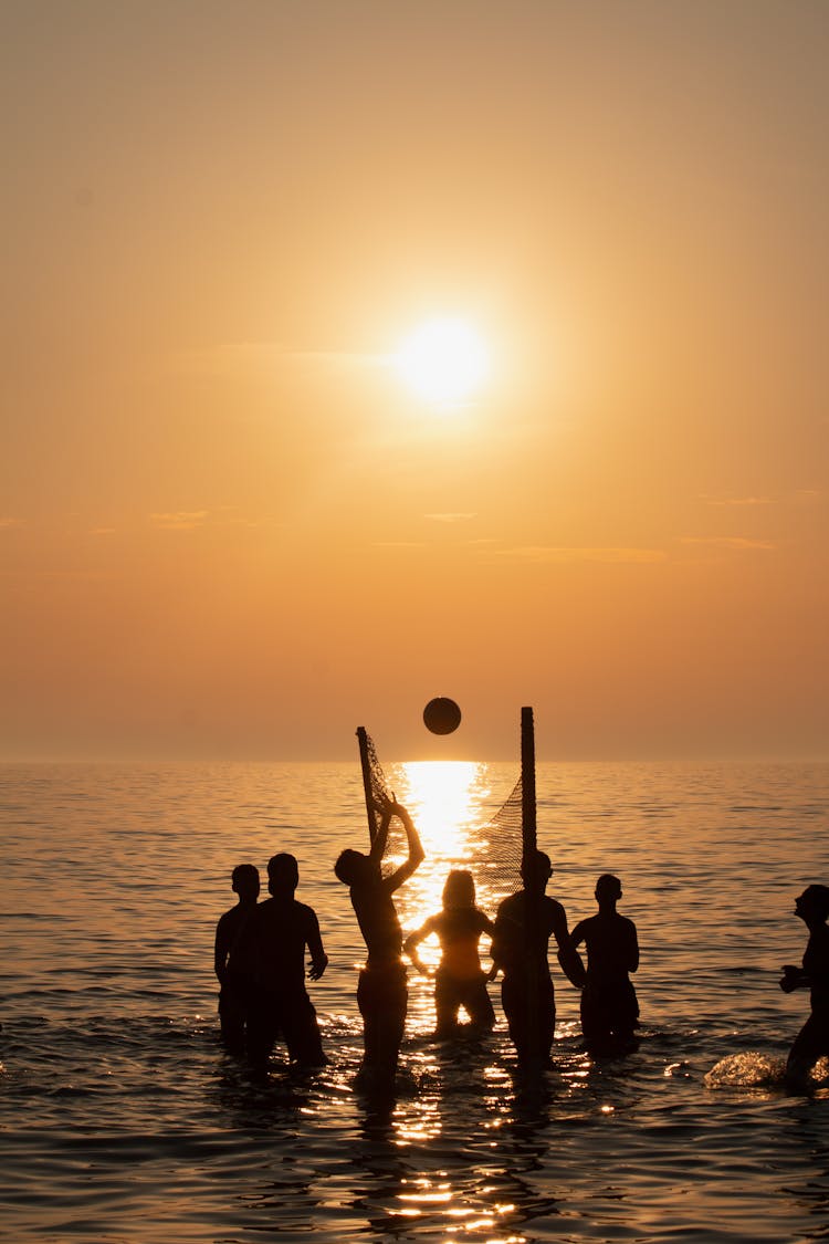 Silhouette Of People On The Beach During Sunset