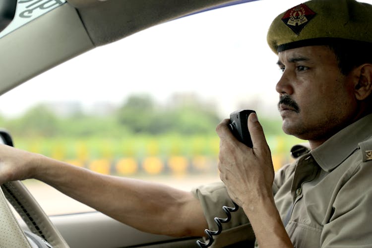 A Policeman Talking On The Radio