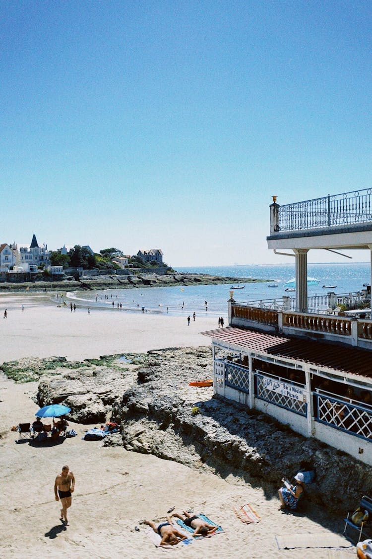 People Sunbathing On The Beach