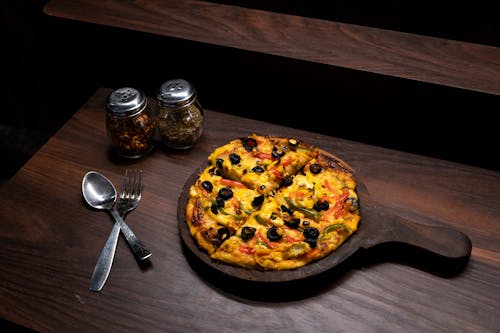 Pizza on Brown Wooden Table