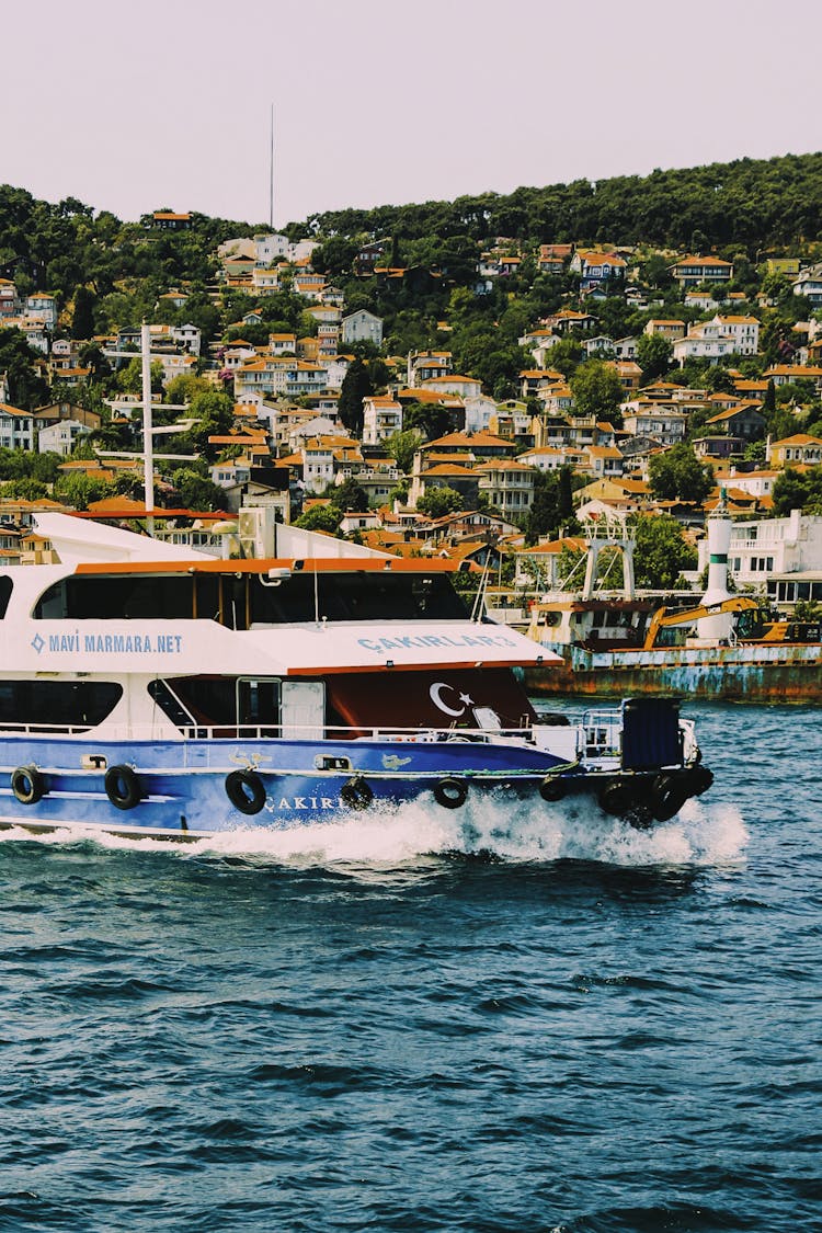 A Boat Sailing Near A Coastal City