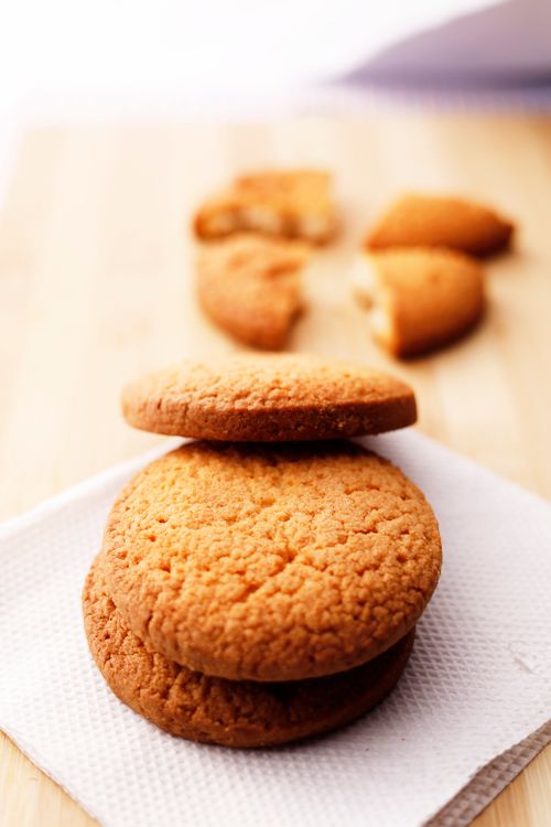Free Close-up of freshly baked cookies stacked on a napkin, highlighting their texture. Stock Photo