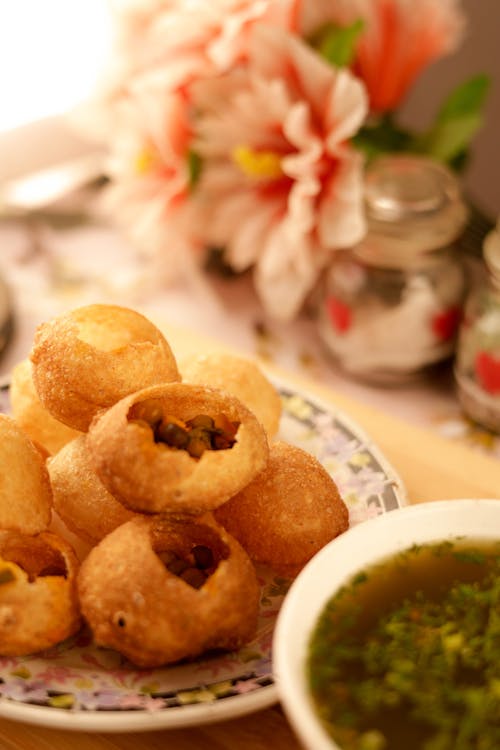 Free Pani Puri on Floral Ceramic Plate Stock Photo