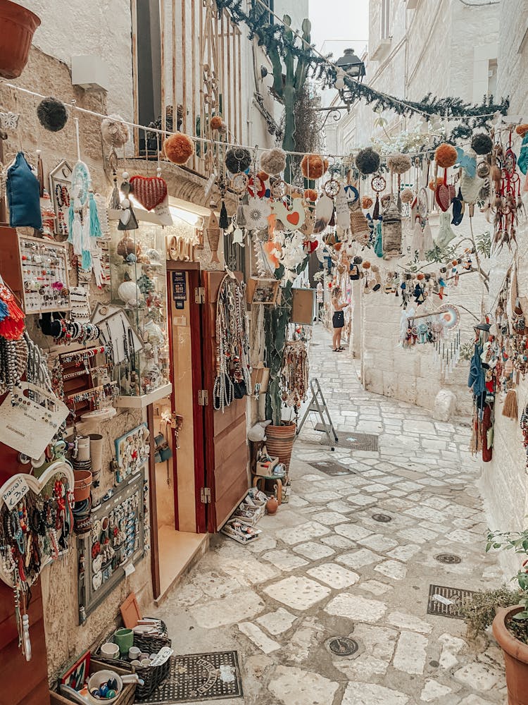 Assorted Ornaments And Accessories Displayed On A Store On Narrow Street