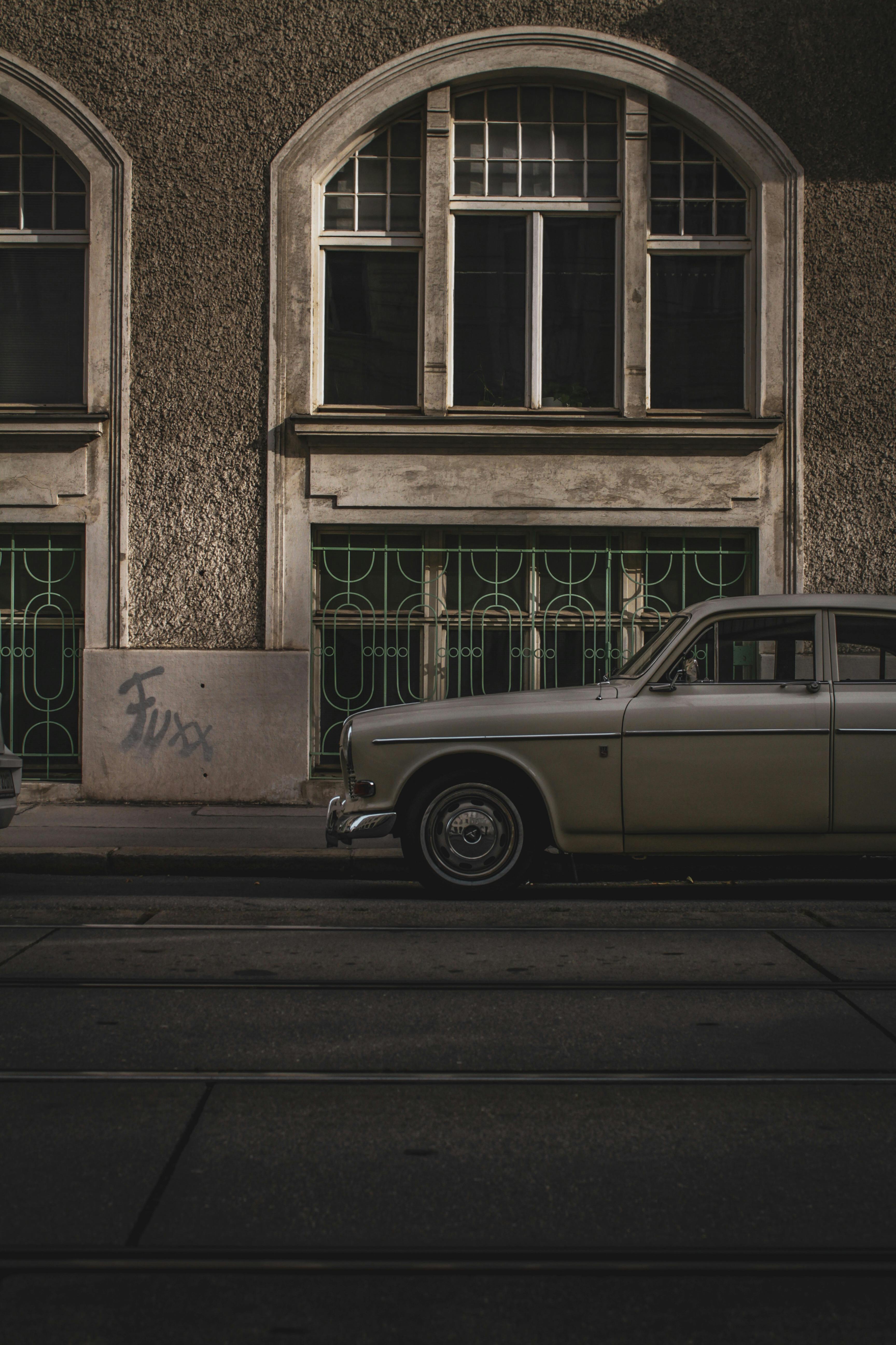 silver old fashioned car on street