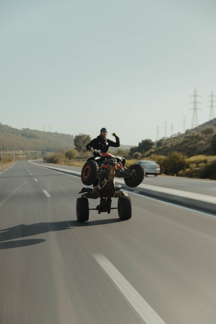 A Person Riding Motorcycle On Road