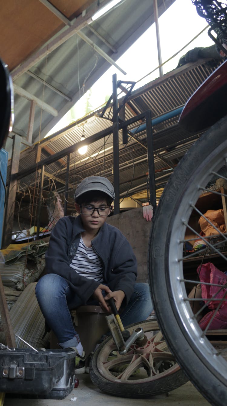 Young Mechanic Changing Bike Tire