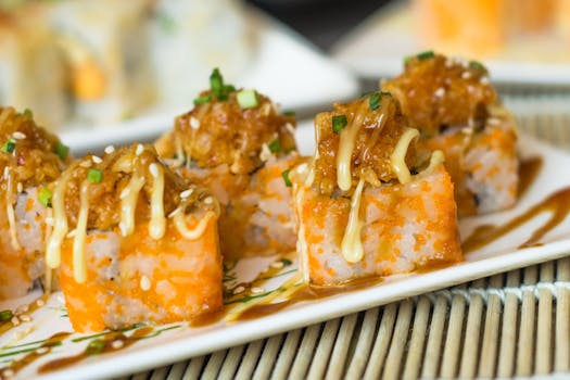 Delicious sushi rolls topped with sauce and green onions, perfect for Japanese cuisine lovers.