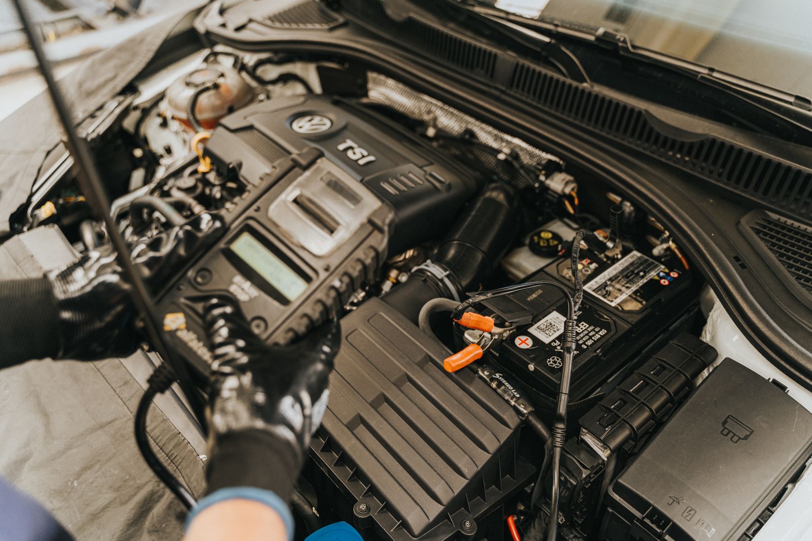 Mechanic carrying out engine-bay diagnostic testing