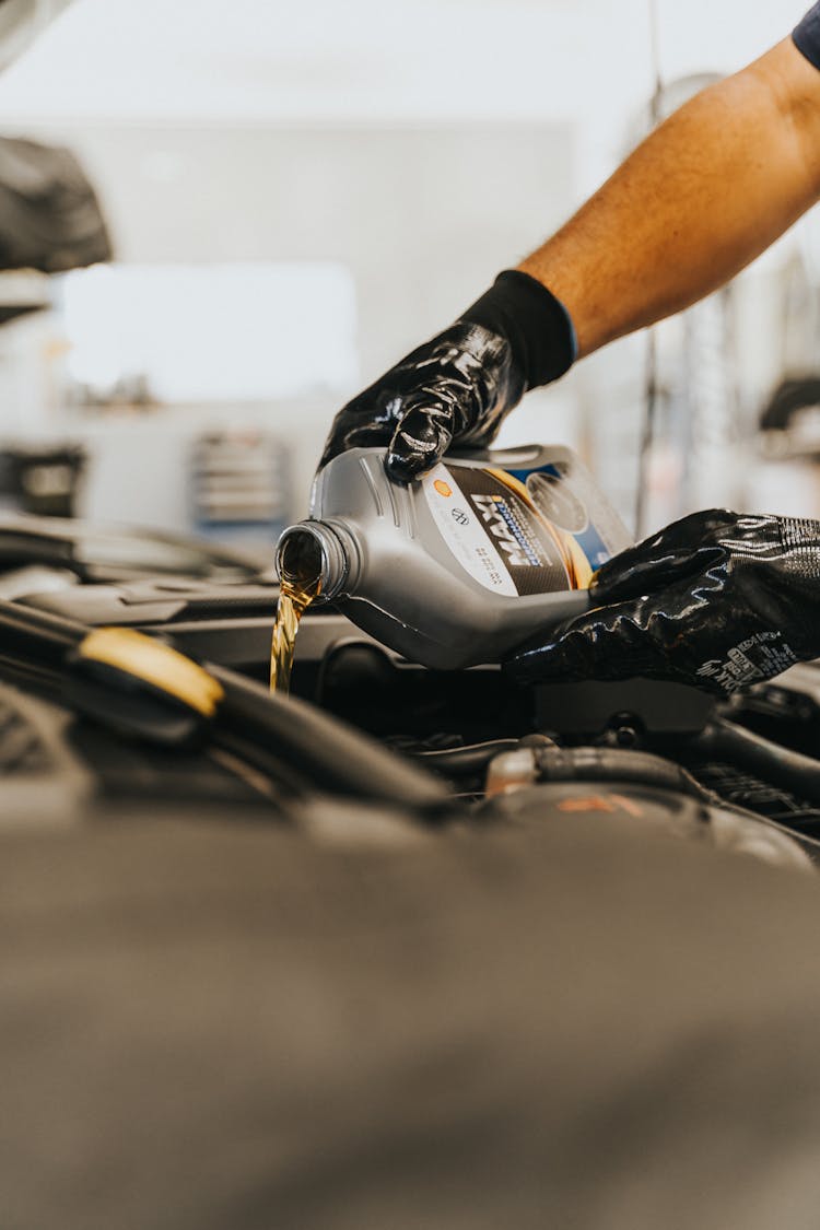 Close Up Of Pouring Oil To Engine