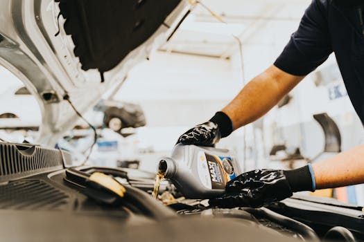 Hands Pouring Oil to Engine