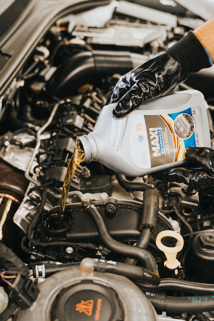 Hand Pouring Oil To Engine