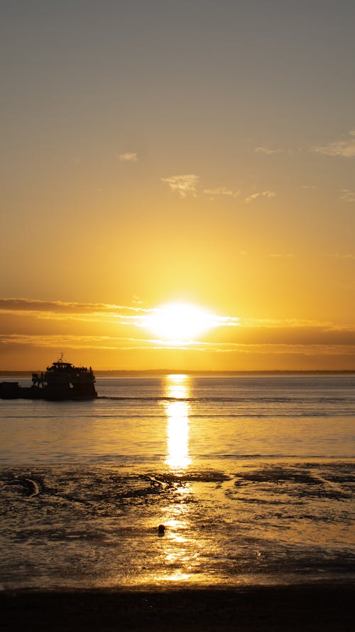 Silhouette of Boat on Sea during Sunset