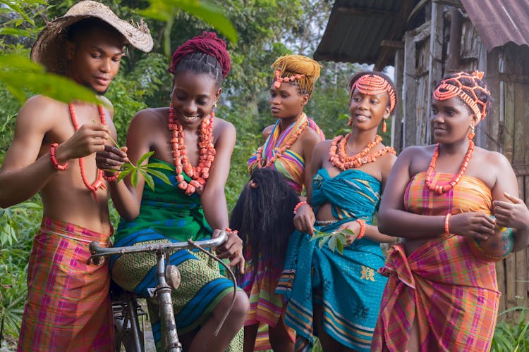 A Group Of People In Traditional Dresses